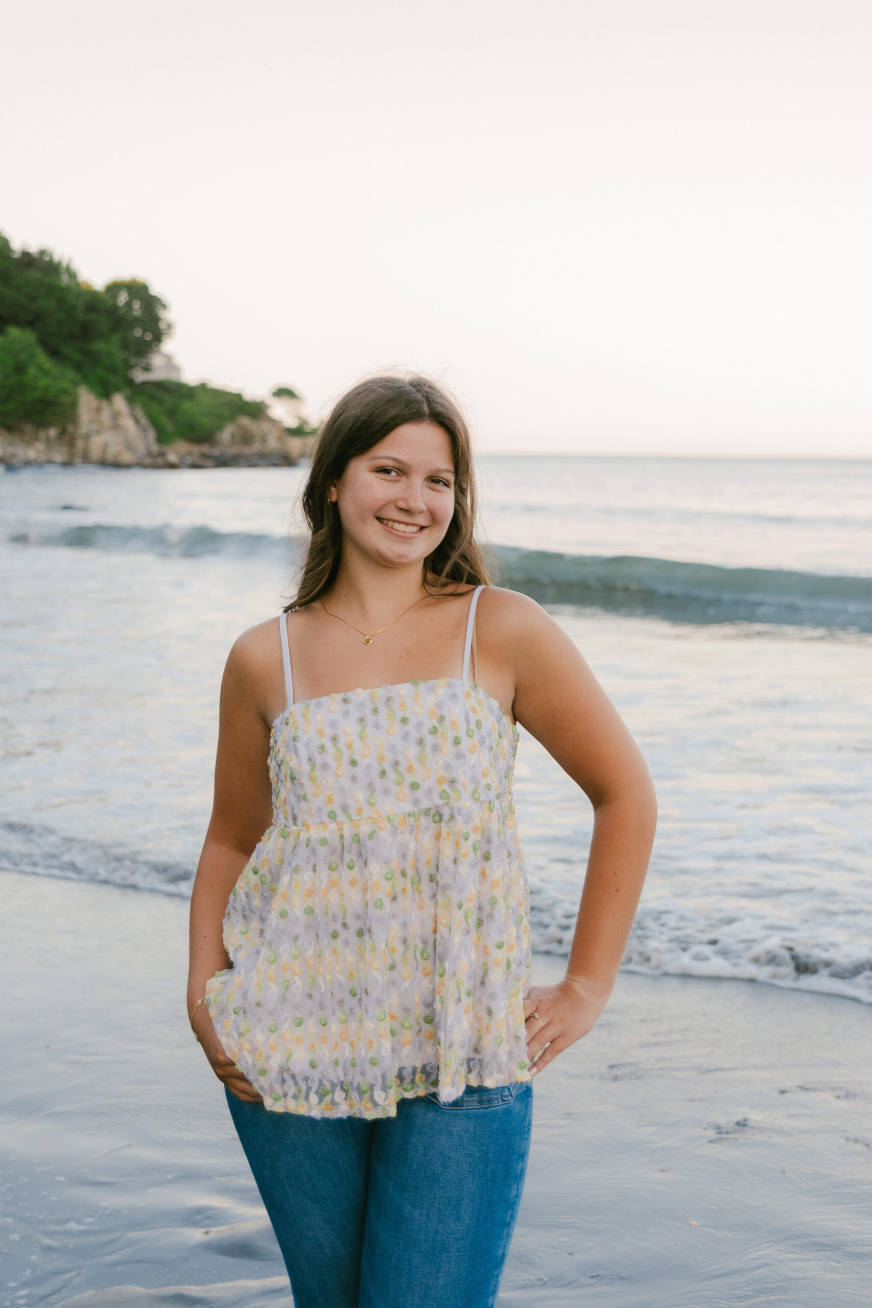 A picture of Rebecca smiling at the beach